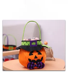 Plush pumpkin candy bag with a black wizard hat and purple striped bow detail