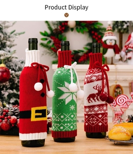 Detailed view of three knitted Christmas wine bottle covers with festive patterns