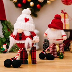 Detail of Christmas gnomes with knitted hats and heart motifs on red gift boxes