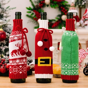 Detail of Christmas knitted wine bottle covers with reindeer, Santa, and snowflake patterns