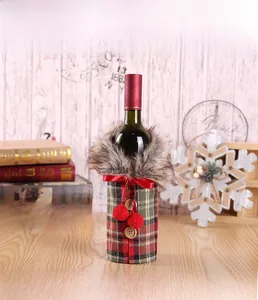 Close-up of Christmas wine bottle cover with red plaid fabric and faux fur trim decor
