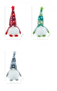Close-up of three glowing Christmas gnomes with knit snowflake hats in red, green and grey