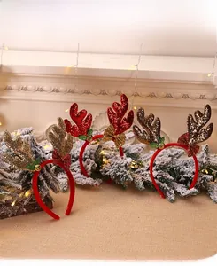 Detail showing glittery reindeer antlers headbands with bows and bells for Christmas