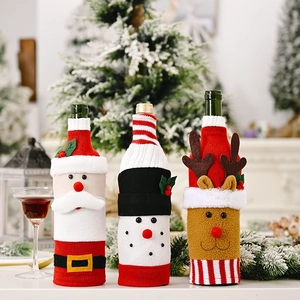 Detail of Christmas wine bottle covers featuring Santa, snowman and elk in knit fabric