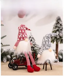 Close-up of festive Christmas gnomes with knitted snowflake hats and plush white beards