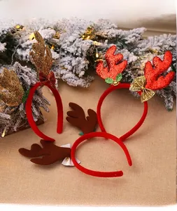 Detailed view of three festive Christmas antler headbands with sequins and bells