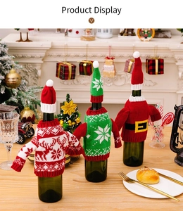 Detailed view of three festive knitted wine bottle covers with reindeer and Santa designs