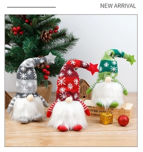 Close-up of a set of three knitted Christmas gnomes with glowing lights and snowflake patterns