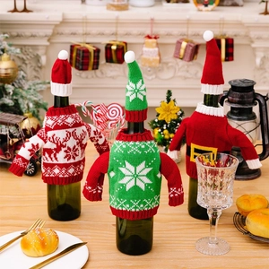 Three-piece knitted Christmas wine bottle covers with reindeer, snowflake, and Santa motifs