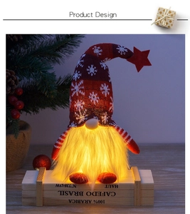 Detail of glowing Christmas gnome with snowflake knit hat and warm LED light effect