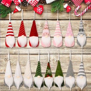 Set of fifteen handmade knitted Christmas gnomes with colorful hats on a rustic wood background