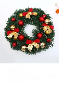 Detailed close-up of a Christmas wreath with festive red and gold ornaments and bows