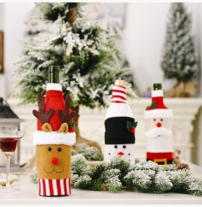 Detail of Christmas wine bottle covers featuring Santa, snowman and reindeer designs