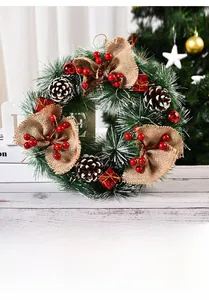 Detailed close-up of Christmas wreath with pine needles, cones, berries and linen bow decoration