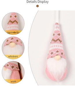 Close-up of pink knitted gnome ornament showing details of hat, whiskers and texture
