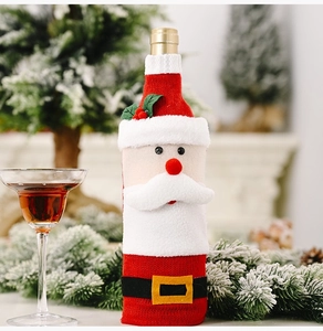 Close-up of knitted Santa Claus wine bottle cover with soft white fleece trim details