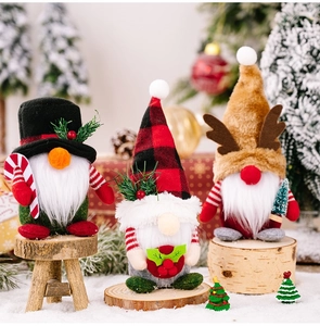 Detailed view of three festive Christmas gnomes with plaid hats and reindeer antlers