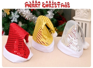 Close-up of sparkling sequin Christmas hats in red, gold and silver with white plush trim