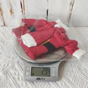 Detailed view of the 29.4g lightweight knitted Christmas wine bottle cover packaging