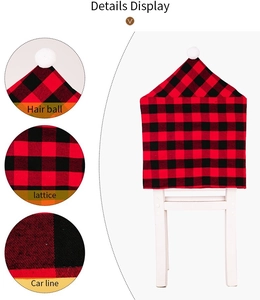 Detailed view of red black plaid Christmas chair cover with white pom pom and fine stitching