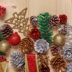 9-piece set of natural pine cones and festive ornaments on wooden background