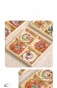 Detail of wooden Christmas ornaments featuring snowflakes and reindeer in a storage box