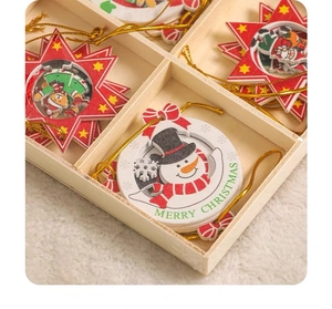 Close-up of wooden Christmas ornaments with snowman and Santa designs in a partitioned box
