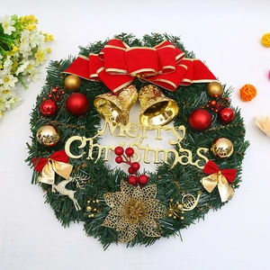 Christmas wreath with red velvet bow, gold bells, and Merry Christmas sign for door decor