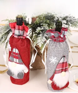 Detailed view of red and grey gnome wine bottle covers with plaid hats on a festive table