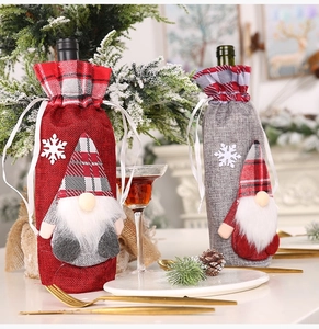 Detail of Christmas gnome wine bottle covers with red and grey linen fabric and drawstrings