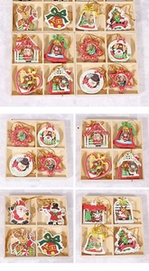 Detail of wooden Christmas ornaments featuring hand-painted reindeer and snowflakes with cords