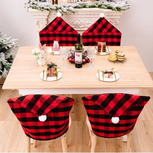 Red and black checkered Christmas hat chair covers with white pom poms for home decor