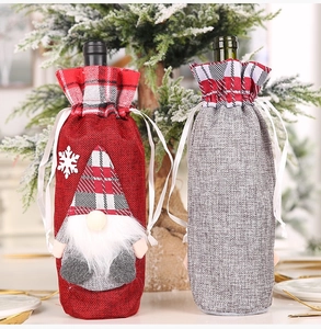 Detail of Christmas wine bottle covers with gnome design and rustic linen texture
