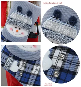 Detailed view of the knitted cuff and small silver metal bells on the Christmas snowman stocking