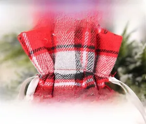 Detail of Christmas wine gift bag with red plaid fabric and white satin drawstring