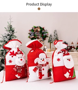 Close-up of three knitted Christmas drawstring gift bags featuring Santa, Reindeer, and Snowman