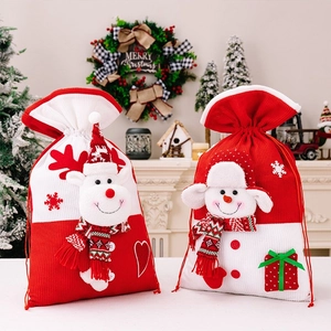 Detailed view of Christmas knitted gift bags with 3D reindeer and snowman characters