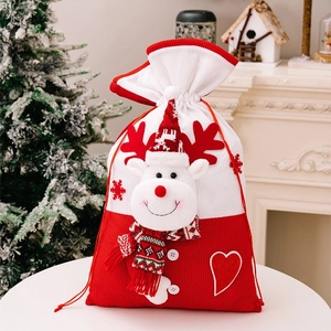 Detail of knitted Christmas gift bag with a 3D plush reindeer and drawstring closure