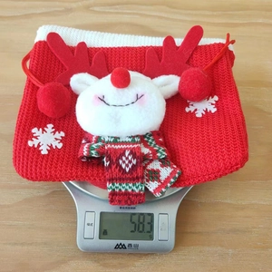 Close-up of a Christmas reindeer gift bag on a digital scale showing 58.3g weight