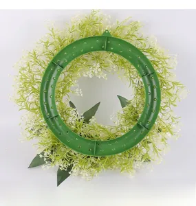 Detailed back view showing the green plastic circular frame and hanging holes of the floral wreath