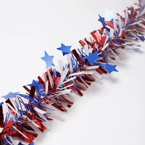Detail of red white and blue patriotic garland with metallic star accents for festive decor