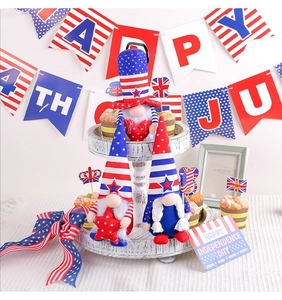 Three USA Independence Day gnomes with stars and stripes displayed on a white tiered tray