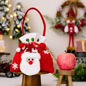 Knitted Christmas gift bag featuring a 3D Santa Claus face and white snowflake embroidery