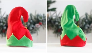 Close-up of red and green Christmas elf hats with jagged trim and golden bells detail