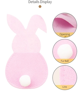 Detailed view of pink felt Easter bunny cutlery holder with white fur ball tail and stitching