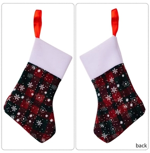 Detail of Christmas plaid mini stocking with white snowflake prints and plush cuff