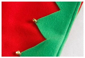 Detailed macro view of festive red and green felt fabric with small golden jingle bells