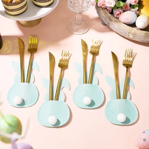 Set of four blue felt Easter bunny cutlery holders with white pom-pom tails and gold utensils