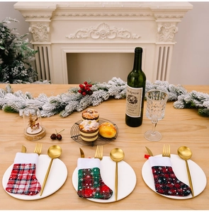 Detailed view of Christmas plaid mini stockings used as festive cutlery holders for tables