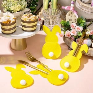 Yellow bunny-shaped felt cutlery holders with plush tail for Easter table decor